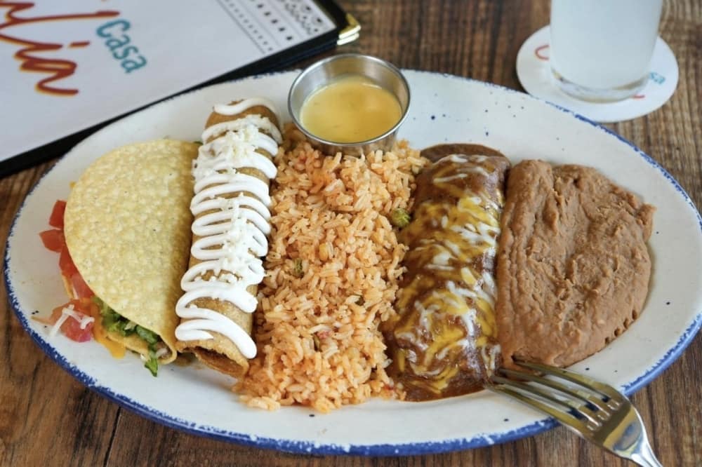Casa Julia Tex-Mex offers lunch items including pork tamales, crispy beef tacos, and chicken flautas, served with rice and beans. (Courtesy Casa Julia Tex-Mex)