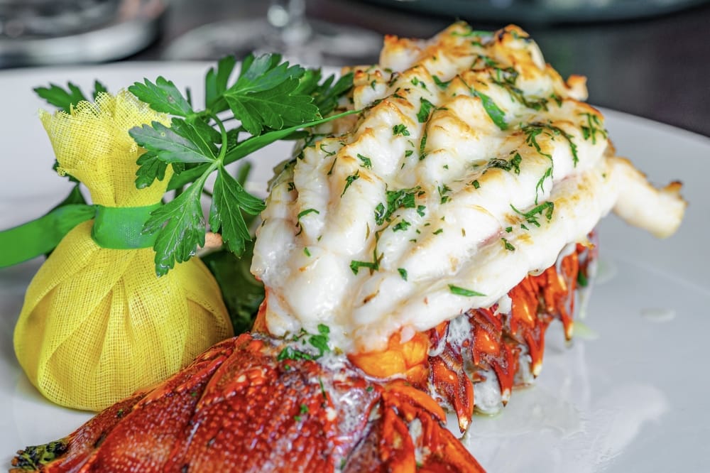 The Lobster Tail ($125) is butter finished and carved tableside with parmesan mashed potatoes and asparagus. (Courtesy Truluck's)